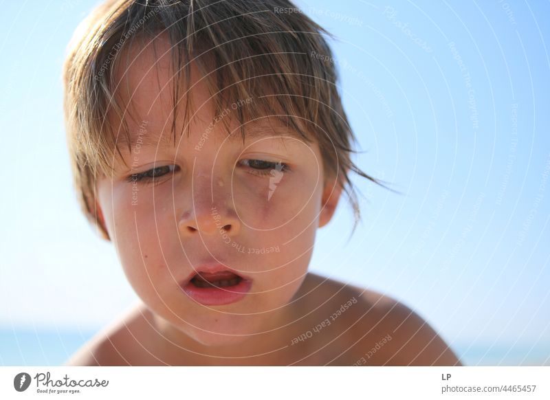 face of a beautiful child looking down and wondering Individual Isolated Single Abstract Flow Children's game Childhood memory candid dreamy singular
