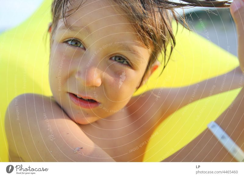 face of a beautiful child looking  at the camera Individual Isolated Single Abstract Flow Children's game Childhood memory candid dreamy singular Exceptional