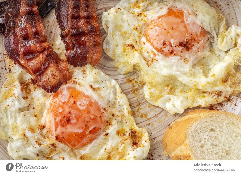 Delicious breakfast of fried eggs and bacon slices food meal nutrient tasty plate stripe piece spice nutrition delicious sunny side up appetizing natural