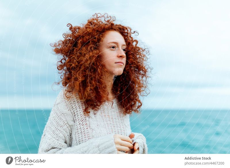 Pensive woman looking away on seashore personality thoughtful individuality female portrait long hair delight knitted ginger hair seaside pensive red hair
