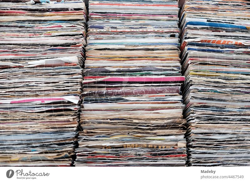 Old vinyl records and singles in frayed colorful paper sleeves at the flea market at the Golden Oldies in Wettenberg Krofdorf-Gleiberg near Giessen in Hesse
