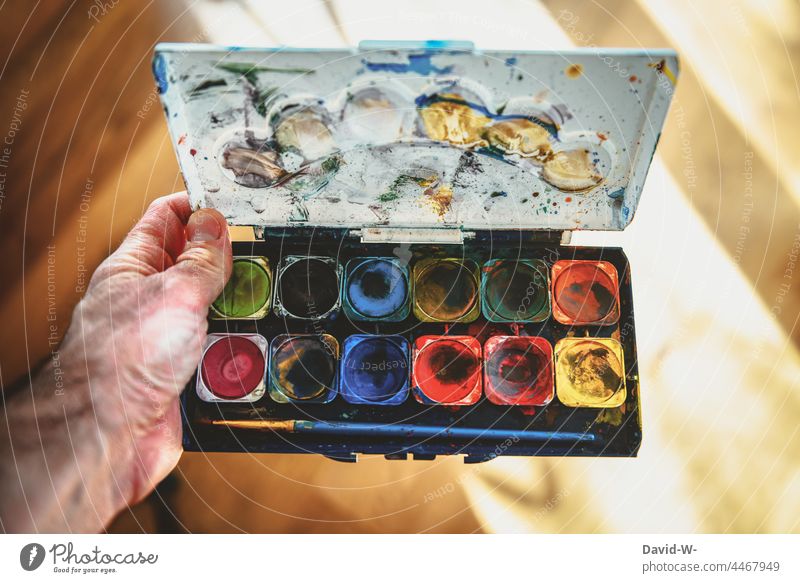 Art and creativity - artist holds a colorful watercolor box in his hand Creativity Artist variegated Painting (action, artwork) creatively Watercolor
