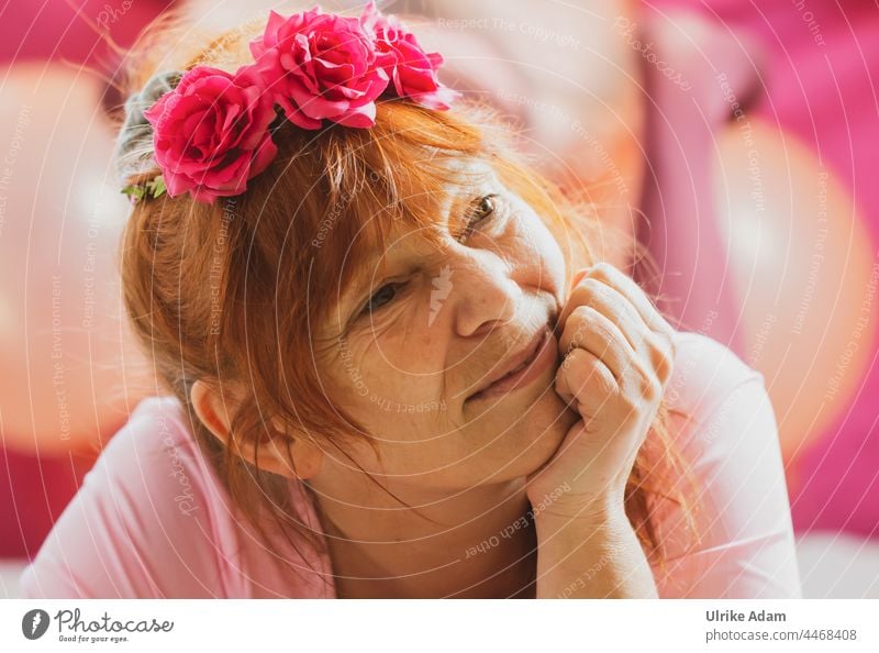 Dreamy in pink - woman with roses in her hair looks dreamy as she props her head up Woman Red-haired Hair accessories Pink Hipster Dreamily Head