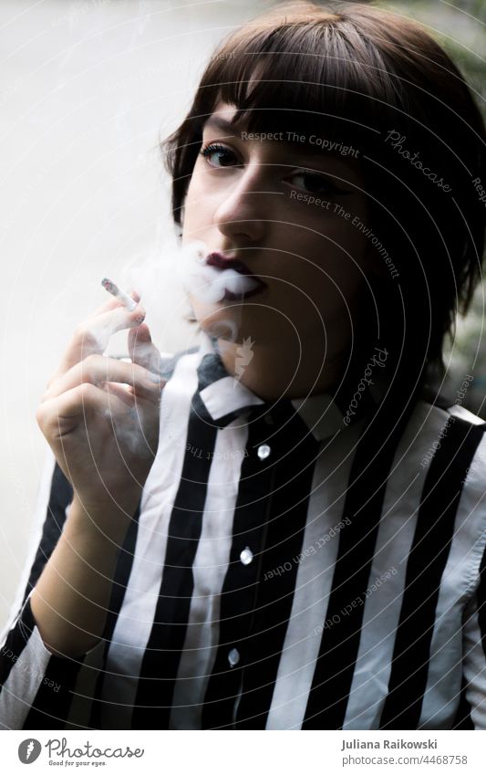 stylish young woman smokes Smoke Cigarette Smoking portrait Woman Unhealthy Cigarette smoke Harmful to health Health hazard Dependence Addiction