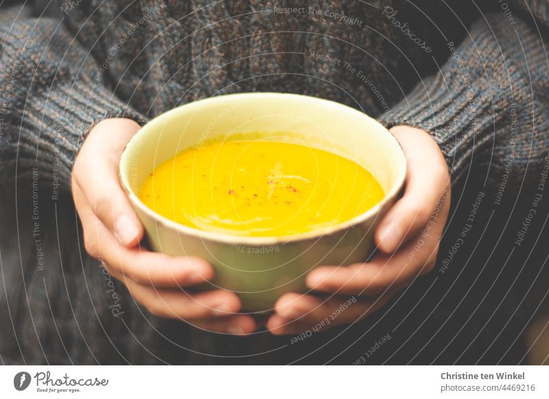 Golden like autumn / pumpkin soup warms us up / delicious and vegan Pumpkin soup shell Vegetarian diet soup bowl Nutrition hands stop To hold on