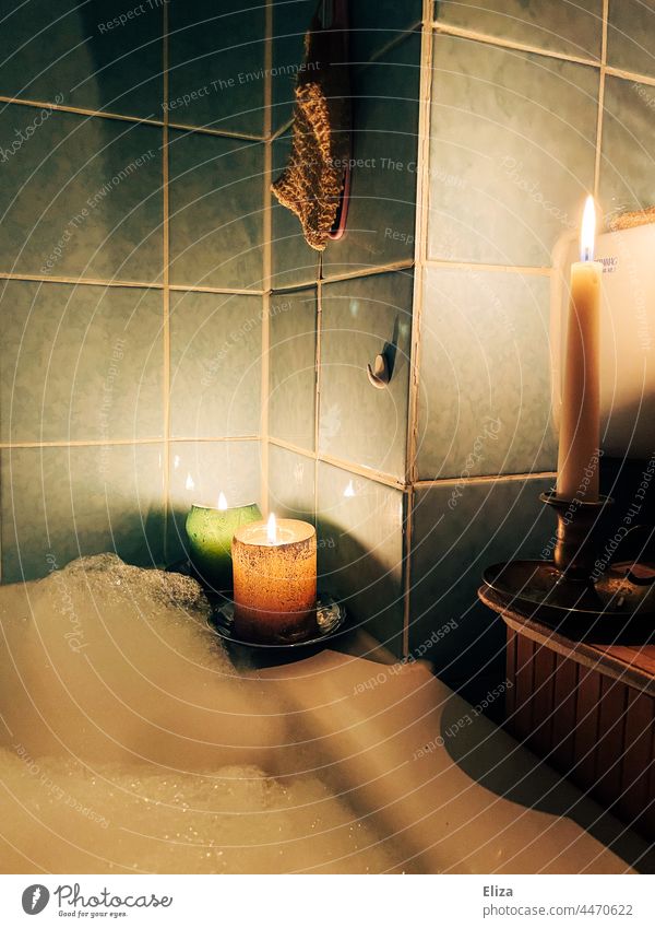 Bathtub with bath foam in candlelight bathe candles Foam bath Bubble bath relaxation bathroom take a bath Tile