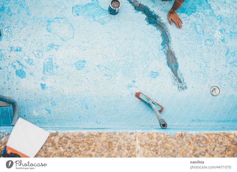 Background of a blue pool maintenance cleaning reform broom broomstick paint painting turquoise profesional damage damaged cracked swimming pool background