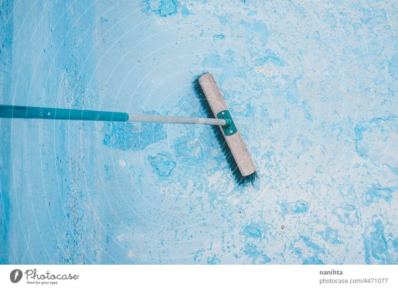 Background of a blue pool maintenance cleaning reform broom broomstick paint painting turquoise profesional damage damaged cracked swimming pool background