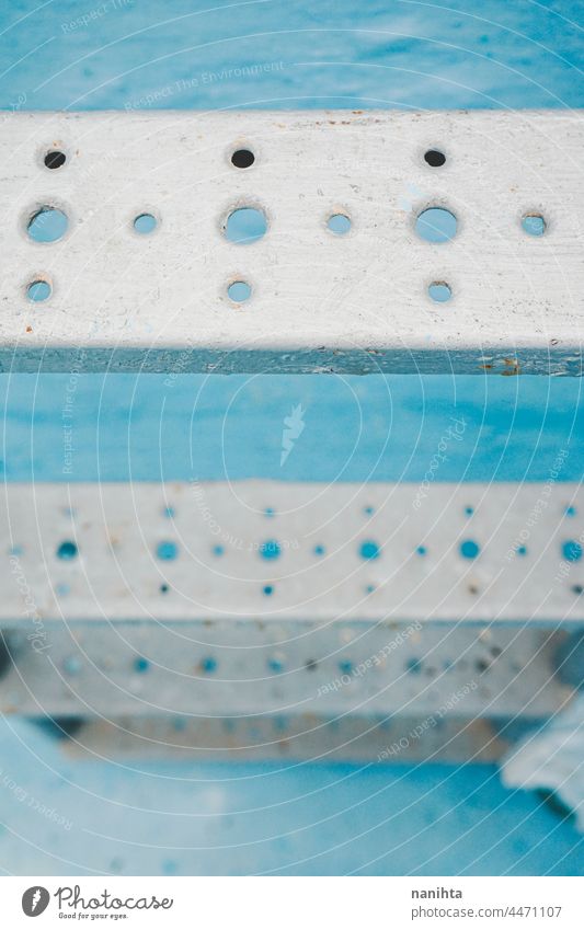 Metallic stairs of a swimming pool close close up metal metallic detail shine blue turquoise lines perspective abstract background structure arquitecture