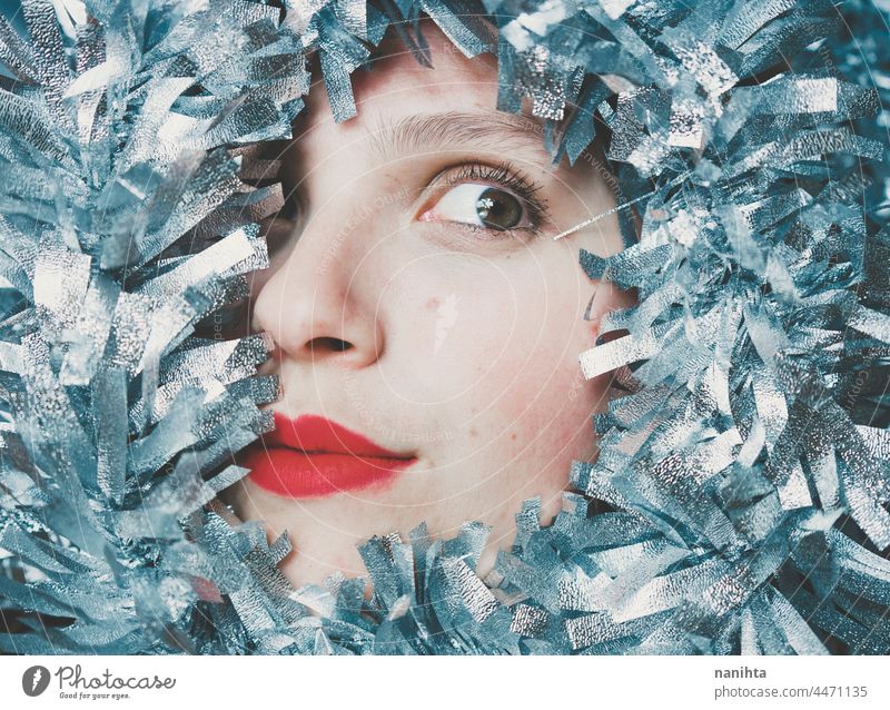 Portrait of a young woman surrounded by a silver garland christmas party cover covering decor decorative decoration fun funny happy happiness face girl glamour