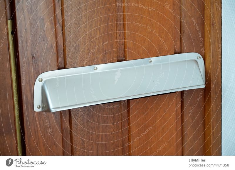 Old aluminum mail slot on a wooden door. Aluminium Mail Wooden door Mailbox Communicate Letter (Mail) Detail Interject Slit Wall (building) Write Metal