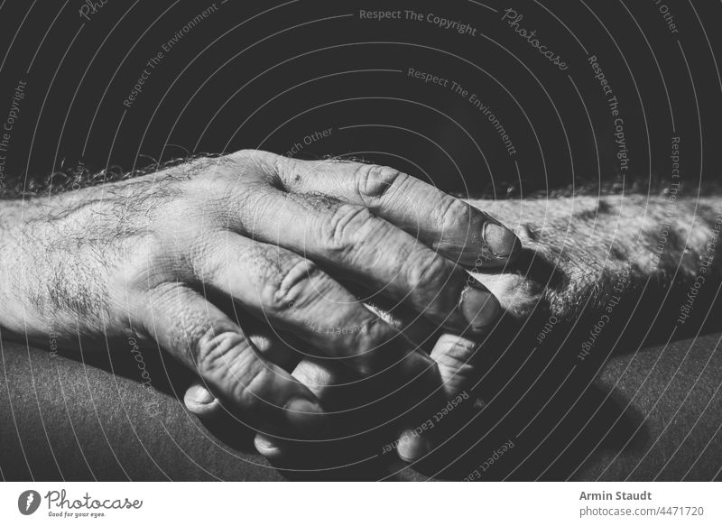 close-up of two hands lying relaxed on top of each other adult black black and white bright bw calm closeup contrast dark expression finger gesture grandpa