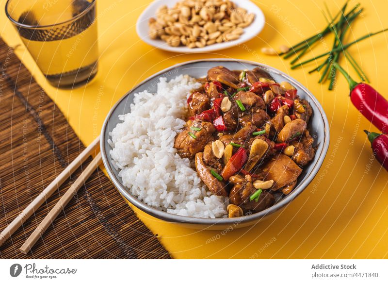 Kung pao chicken with rice chili pepper and peanut kung pao hot chopstick chinese bowl cuisine food spicy cook onion dish composition eat tradition gourmet
