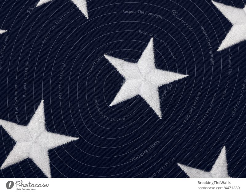 Embroidered stars of American flag blue canton Canton US USA United States white banner cotton canvas heavy background embroidered wave closeup full frame