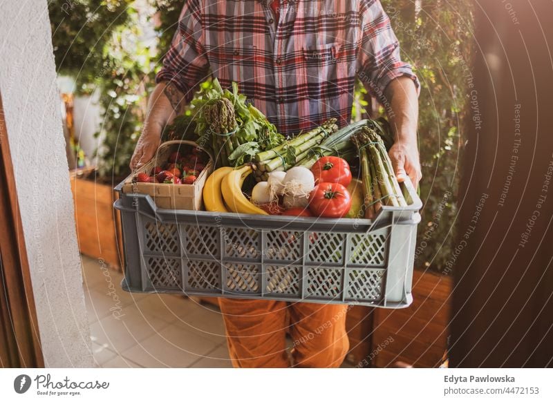 Man delivering fruit and vegetable box adult buying cooking coronavirus courier delivery delivery box delivery man diet door food fresh fresh food freshness