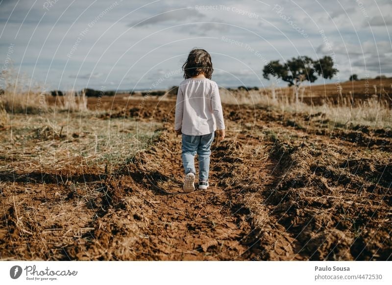Rear view girl walking on plowed path Child Girl Walking 1 - 3 years Caucasian one person Plowed pathway the way forward Human being Colour photo female people