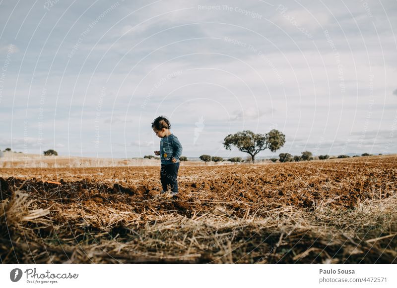 Child standind on plowed field Plowed childhood Authentic Caucasian 1 - 3 years one person Lifestyle Colour photo Infancy Human being Joy Happy