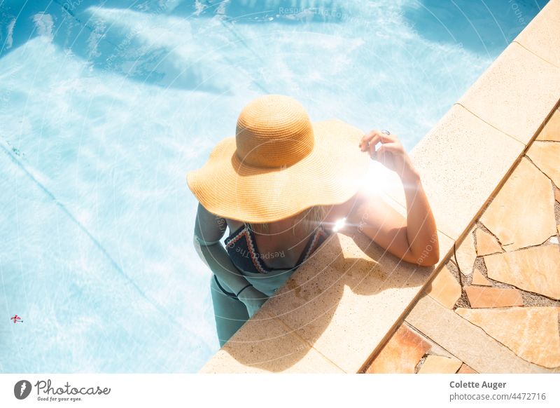 Woman lounging in a pool Vacation mood Relaxation sunshine Summer Sun Sunbathing summer hat Swimming & Bathing Swimming pool