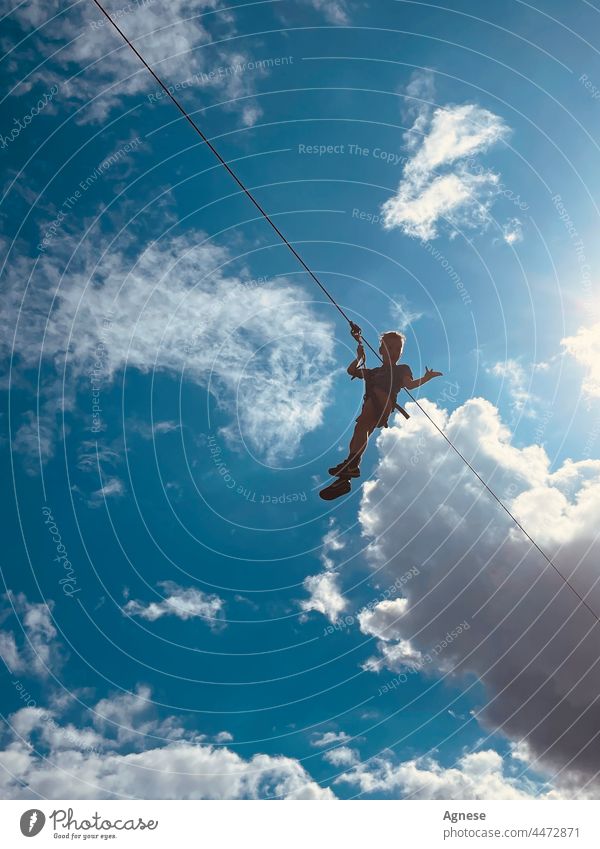 Flying boy in the sky. Ropeway. Sky Boy (child) Blue sky Clouds kid active ropeway Summer sky fun active lifestyle
