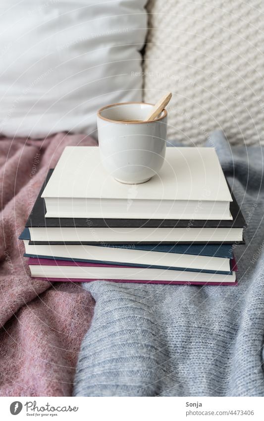 A cup of coffee on a pile of books in bed Coffee Cup Bed Breakfast Morning Hot Caffeine Beverage Espresso Drinking Aromatic Coffee break Wool blanket at home
