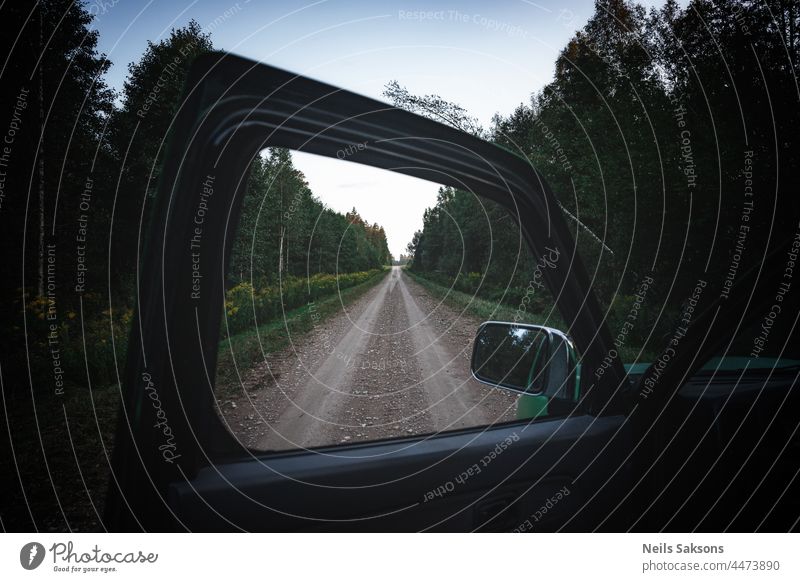 looking through window of opened car door, framing, endless straight forest road adventure background beautiful blue camp current design detail driver frame