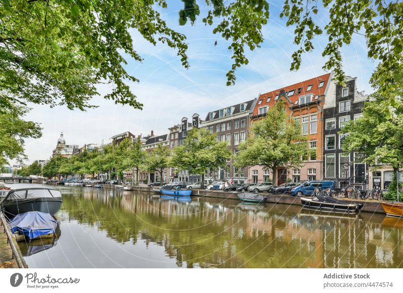 Houses near water canal boat architecture classic culture amsterdam netherlands building river tree street structure tradition district design town window