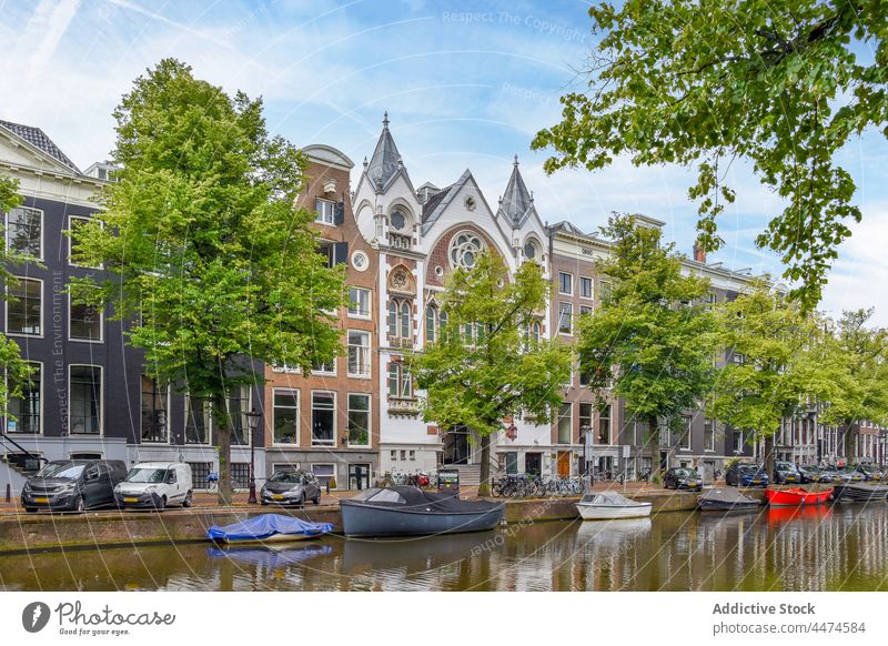 Keizersgracht church near water canal religion historic boat architecture classic culture belief amsterdam netherlands building river tree street structure