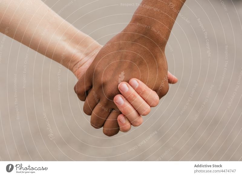 Multiethnic best friends holding hands tenderly women friendship support unity trust equal bonding concept together united relation fondness union humanity team