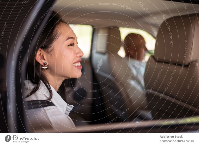 Ethnic woman closing door of car passenger close ride taxi backseat service transport female vehicle automobile well dressed driver public urban commute