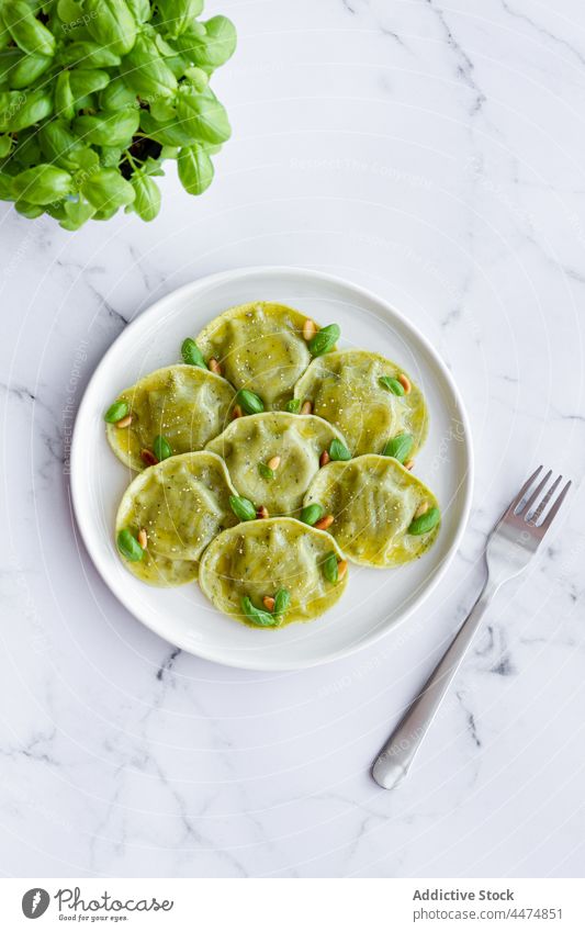 Delicious raviolis on marble table serve food meal basil pasta dough dish cuisine italian plate delicious tasty decor palatable edible portion pine nut kitchen