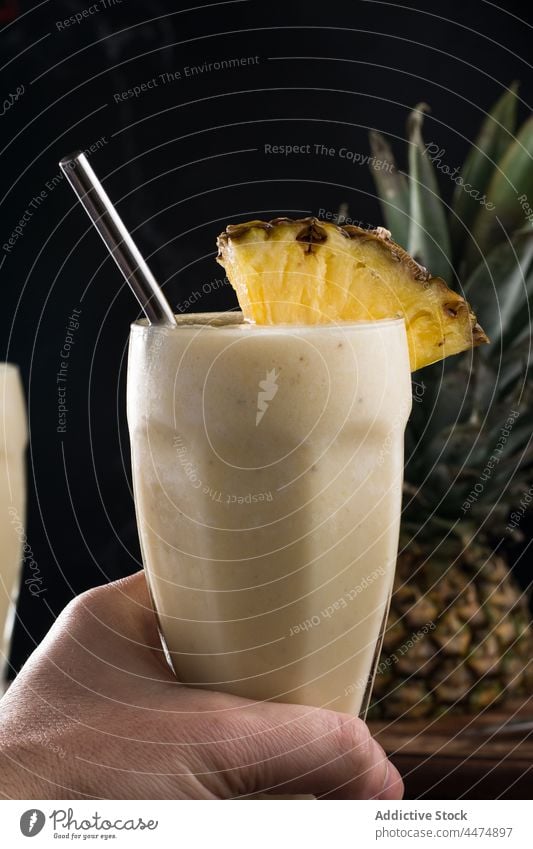 Person with refreshing pina colada smoothie person pineapple coconut exotic fruit tropical serve straw beverage glass milk juice refreshment slice sweet mix