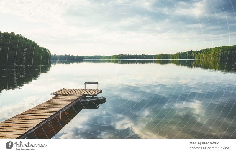 Wooden pier at a calm lake, Poland. nature water sky horizon reflection scenic peaceful beautiful landscape day still relax Lipie Dlugie nobody Europe
