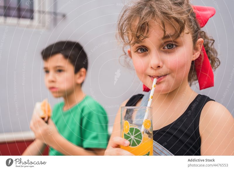 Happy kids eating sandwiches and drinking juice children food childhood snack taste having fun beverage jug laugh smile happy carefree appetite hungry light