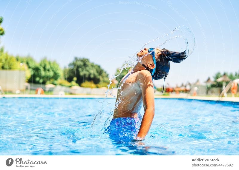 Boy in swimsuit splashing water - a Royalty Free Stock Photo from Photocase