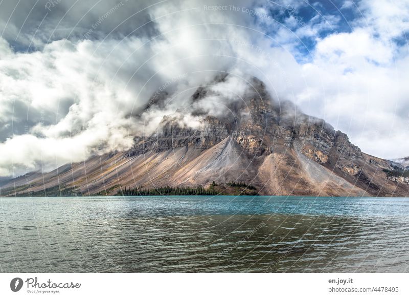 1600 | Mountain lake with clouds hanging low in the mountain bow lake Canada Alberta mountain lake Lake Clouds Weather Vacation & Travel Banff National Park