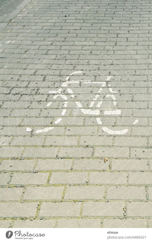 Remains of a bicycle / cycle path / pictogram painted on paving stones Pictogram Bicycle picture Lane markings Transport Paving stone direction of travel