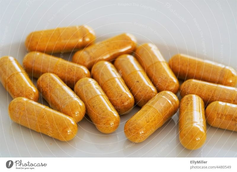 Home made turmeric capsules close up. Food supplement. Capsule Healthy encapsulate Close-up Vitamin seasoning Nutrional supplement manufactured Production