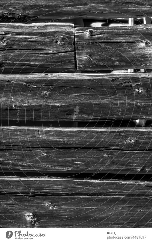 Economical design. Connecting without connecting. Log wall of a hay barn. Butt joint. Block plank Hut Idyll Wooden wall ancient Texture of wood Old Rustic