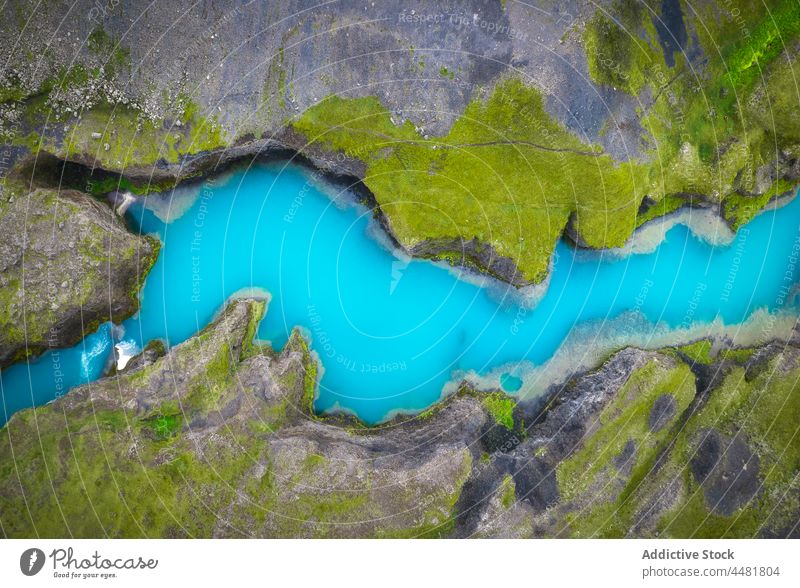 Blue lake surrounded by rocky shores blue water coast background nature waterside stone lakeside waterfront iceland aqua environment scenic formation surface