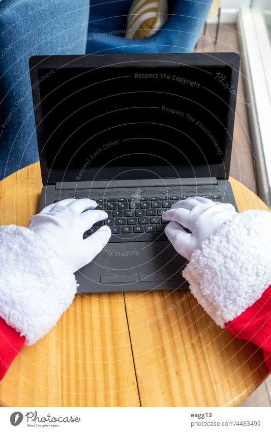 Santa Claus typing from his laptop arm christmas christmas decoration christmas time christmastime communication computer computer monitor concept connection
