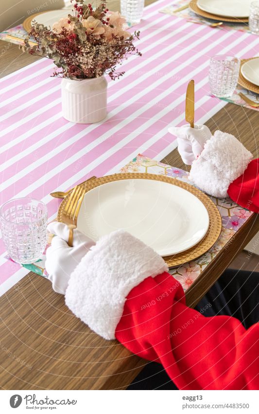 Santa Claus sitting at the table ready to eat arm banquet catering celebrate chairs christmas cutlery december decor design dining elegant empty food fork