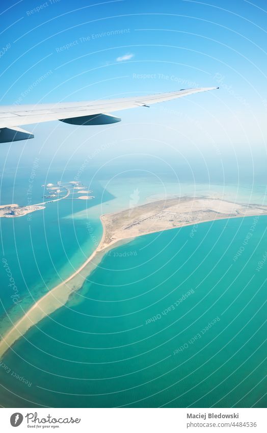 Wing of a plane above the sea, travel and transport industry concept. wing fly aerial island business water trip freedom aircraft flight aviation airplane