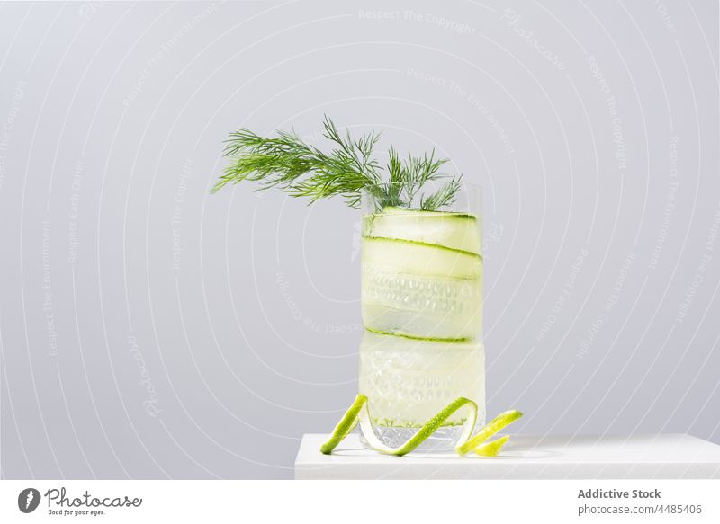 Glass of cold cocktail cocktail decorated with lime zest and fennel gin tonic alcohol beverage refreshment cucumber citrus booze ice serve drink glass cool