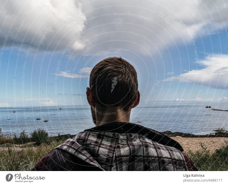 Rear view image of a young man looking at the sea Man Only one man 1 Person Surface of water One young adult man Individual Youth (Young adults) Adults