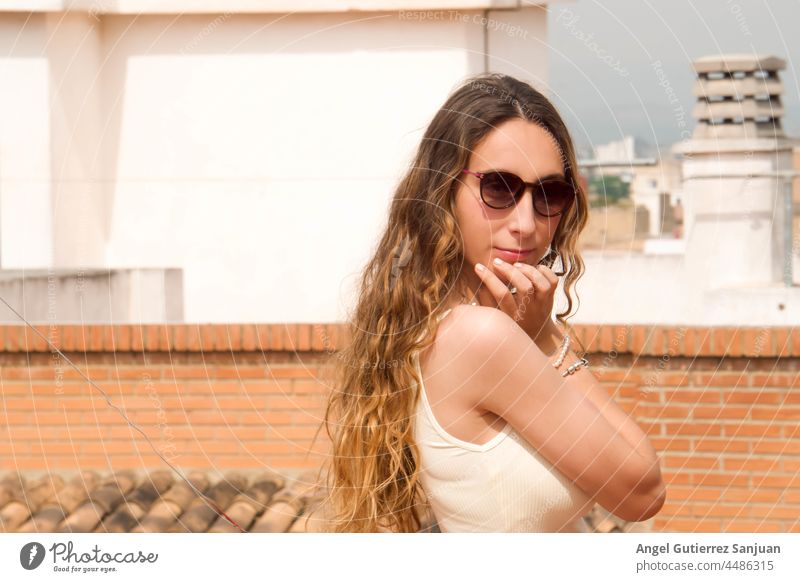 Young woman in sunglasses posing outdoors on a sunny day. young style summer casual one person urban female photography young adult casual clothing carefree