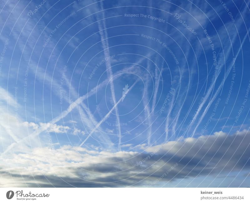Contrails in the sky of passenger planes useless holiday fliers or chemtrails of the conspiracy theory Vapor trail Sky Passenger plane Conspiracy theory Stripe