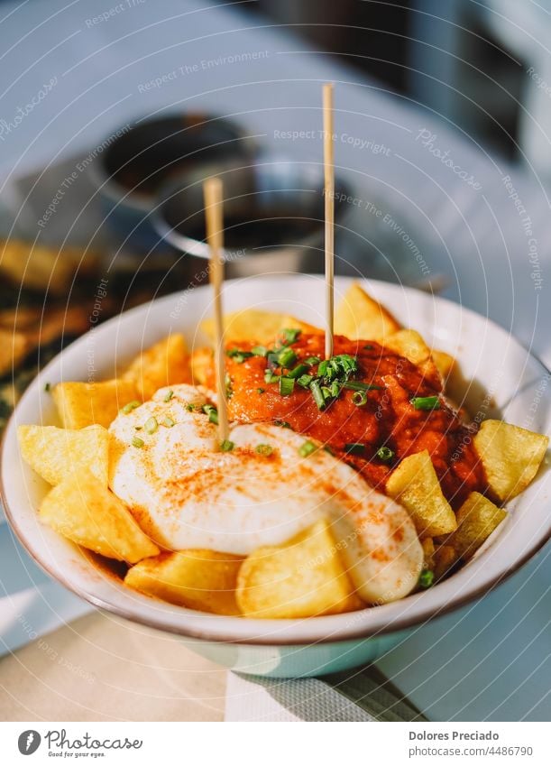 Tipical spanish tapa of potatos and spicy sauce appetizer background baked barbecue bravas brave chili chilli cooking crispy cube cuisine culture delicious