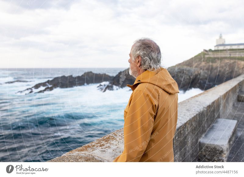 Elderly man observing stormy sea senior wave coast seashore water traveler observe waterfront waterside seascape environment ripple scenery coastal asturias