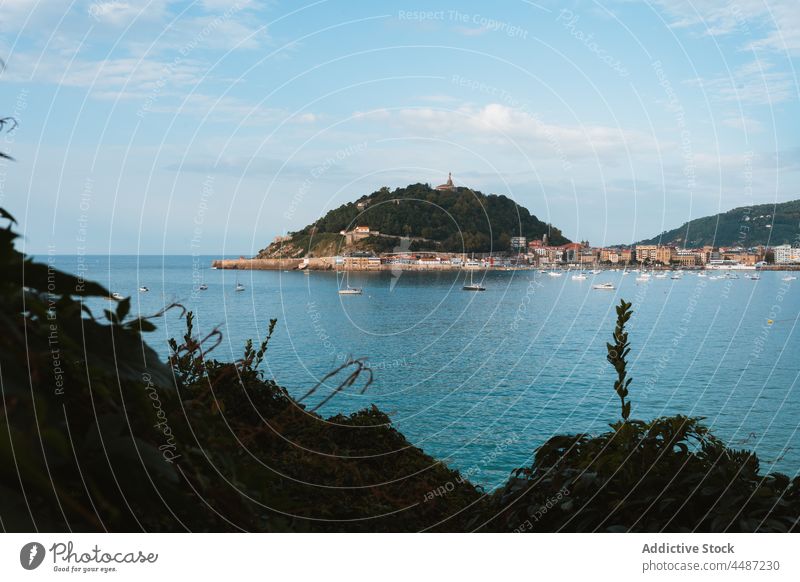 Boats floating in ocean near costal city in sunny day boat water sailboat environment hill cityscape vessel donostia san sebastian spain coast bay of biscay