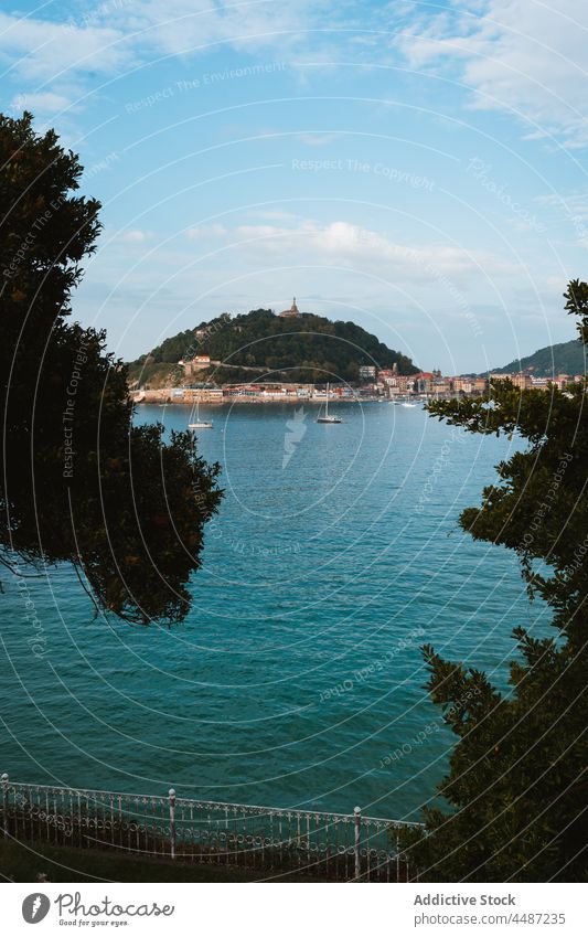 Boats floating in ocean near costal city in sunny day boat water sailboat environment hill cityscape vessel donostia san sebastian spain coast bay of biscay